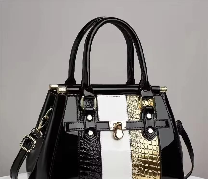 Black patent tote with white and gold striped panels