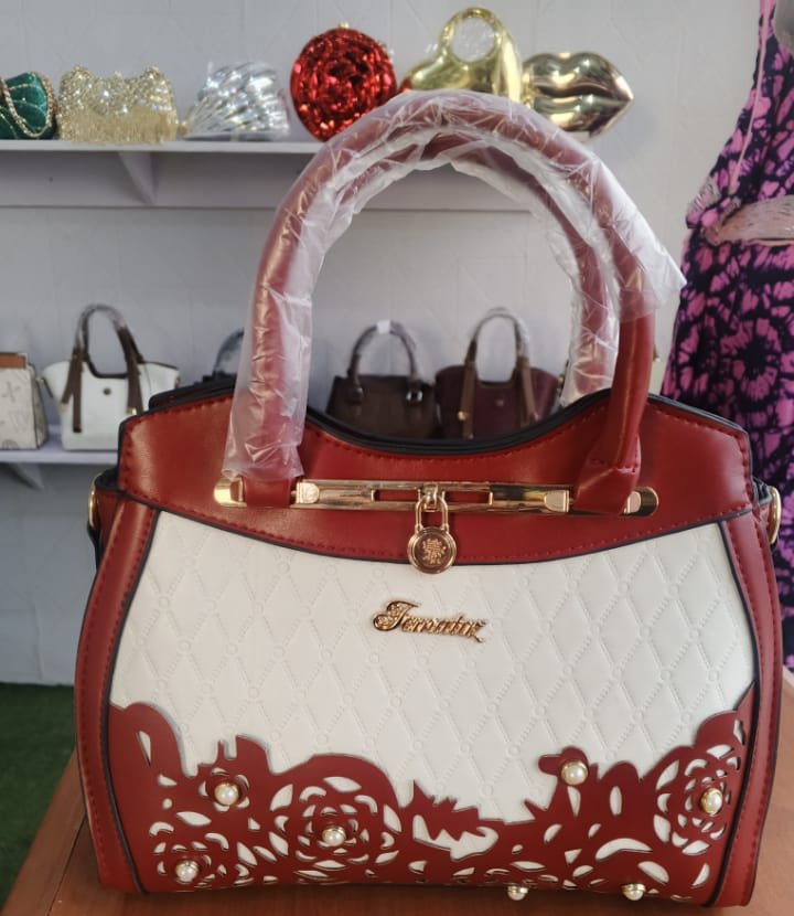 Wine red satchel with gold lace-cutout detail