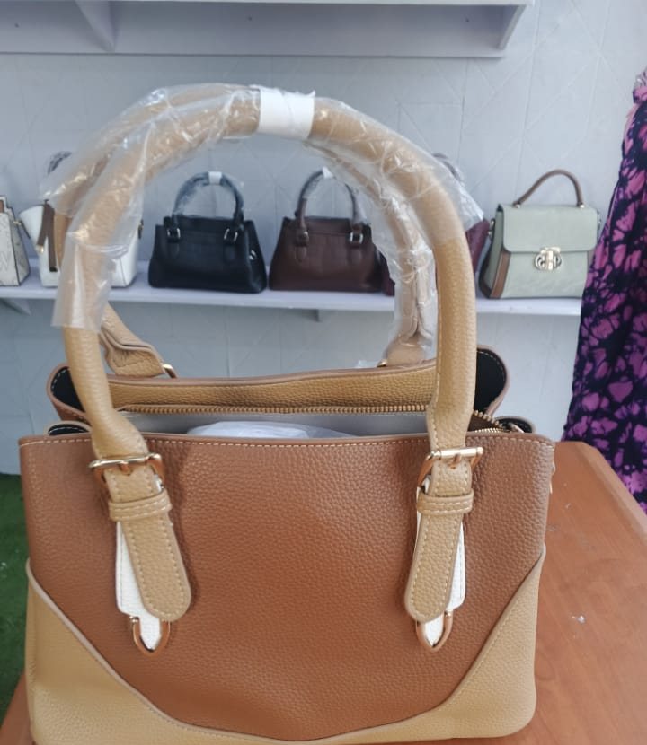Caramel trapeze tote with buckle straps